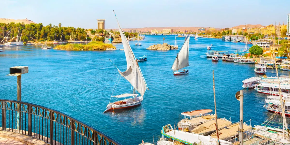 The Nile River flowing through Egypt, showcasing its vast waters and surrounding landscape.