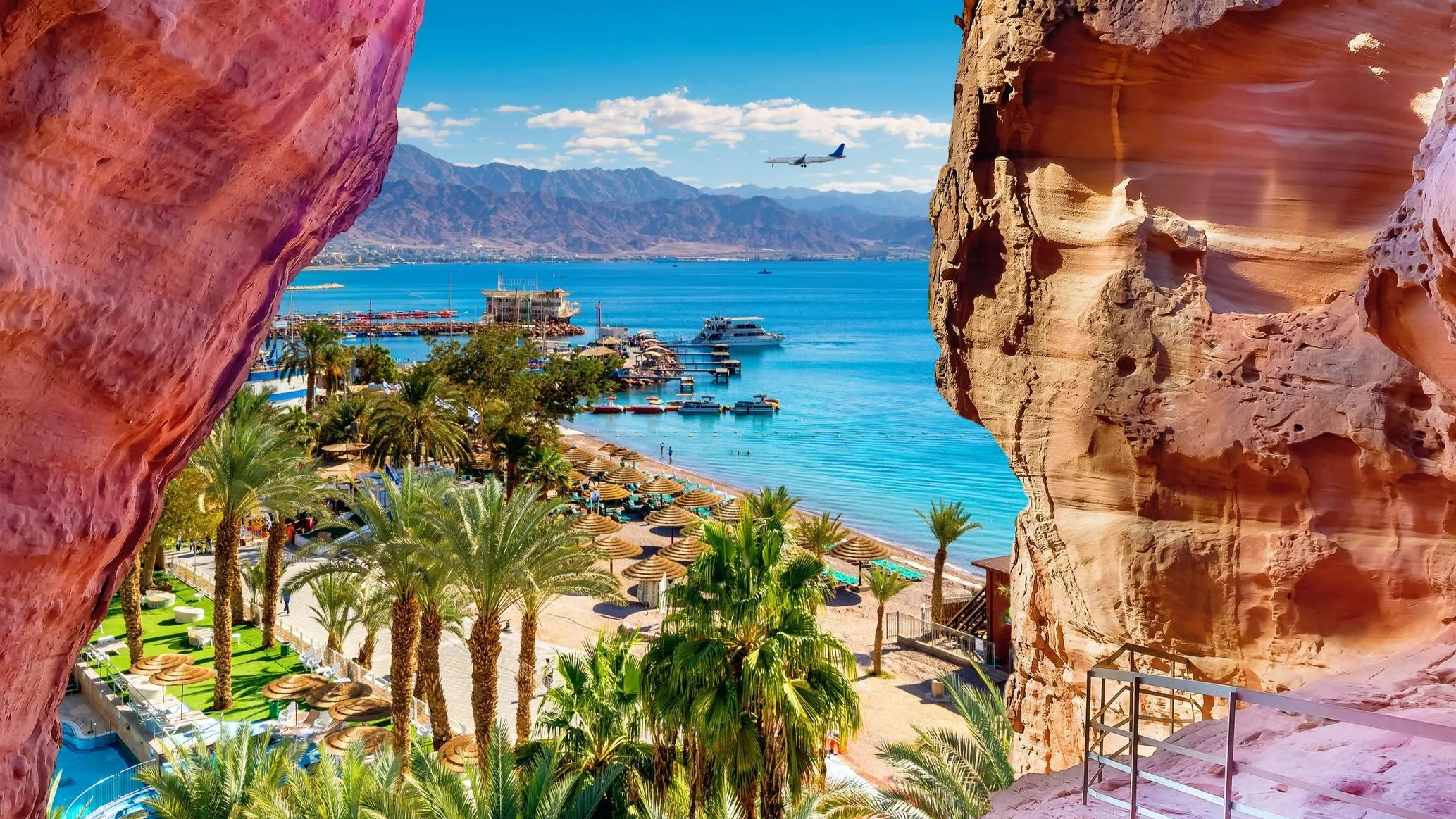 Aqaba and A panoramic view from a rocky outcrop surrounded by vast ocean waters under a clear blue sky in our Jordan itinerary 10 days