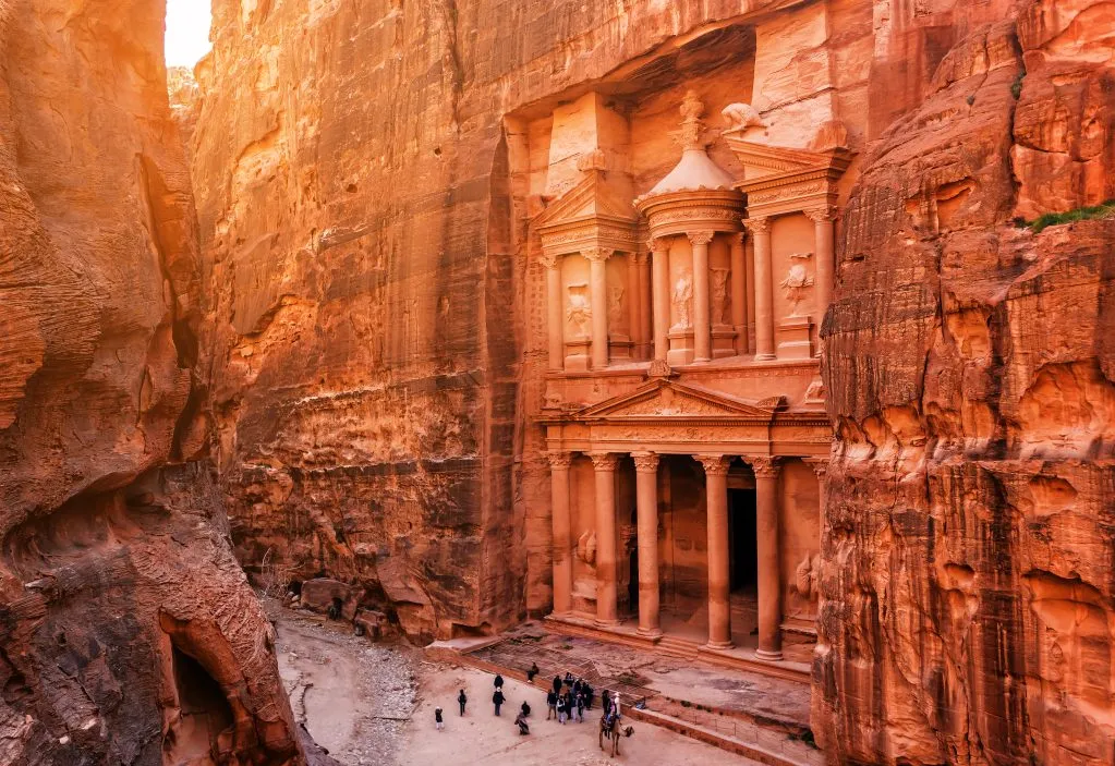 The Treasury of Petra, Jordan, showcasing its intricate facade carved into rose-red rock, surrounded by towering cliffs in Jordan itinerary 5 days